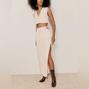 two piece set with a sleeveless, cropped top and a midi skirt with a side slit.